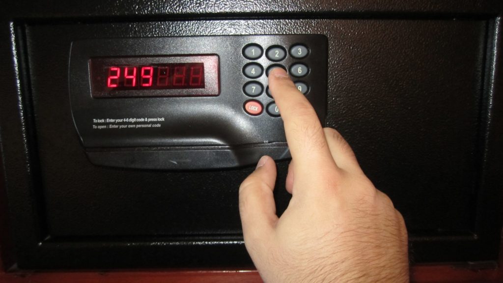 A hotel safe with red numbers